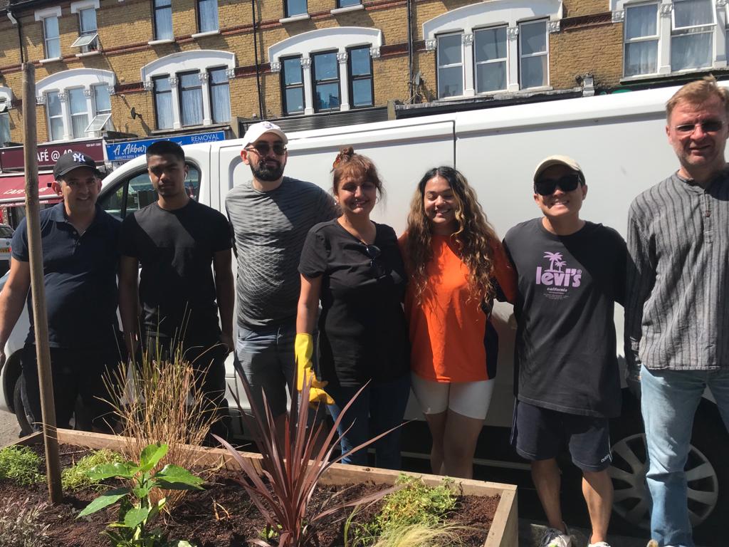 An image of a corporate group doing a days work at the garden