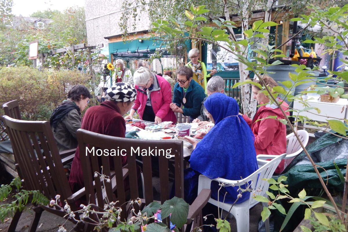 volunteers making mosaics in the garden